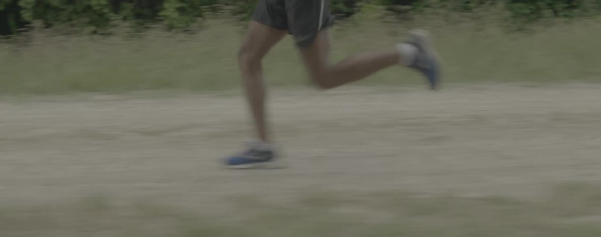 Person is jogging on dirt path in the evening