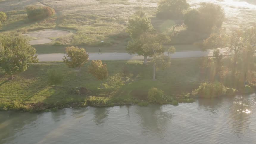 People running alongside a river