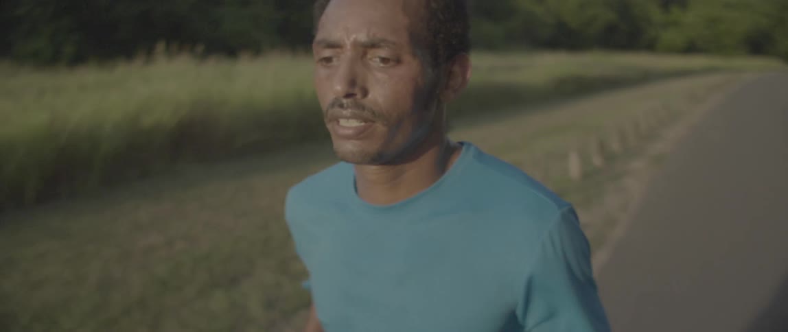 A man jogs on a rural road