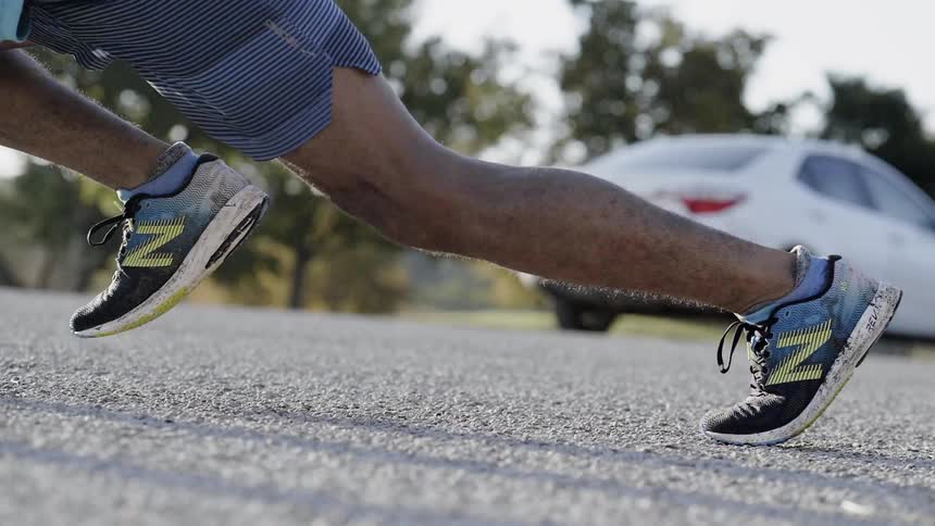 A man exercises in a parking lot
