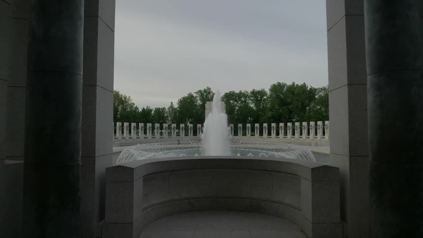 A fountain flows next to a building