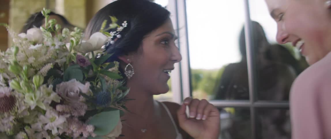 Woman with flowers look through a window