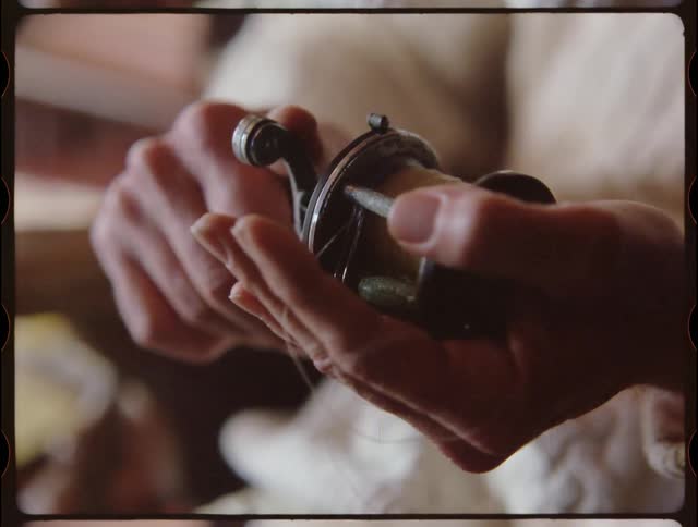 A man fixes a fishing reel