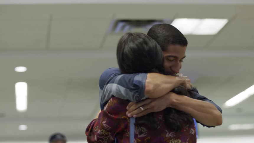 Man and woman embrace at the airport