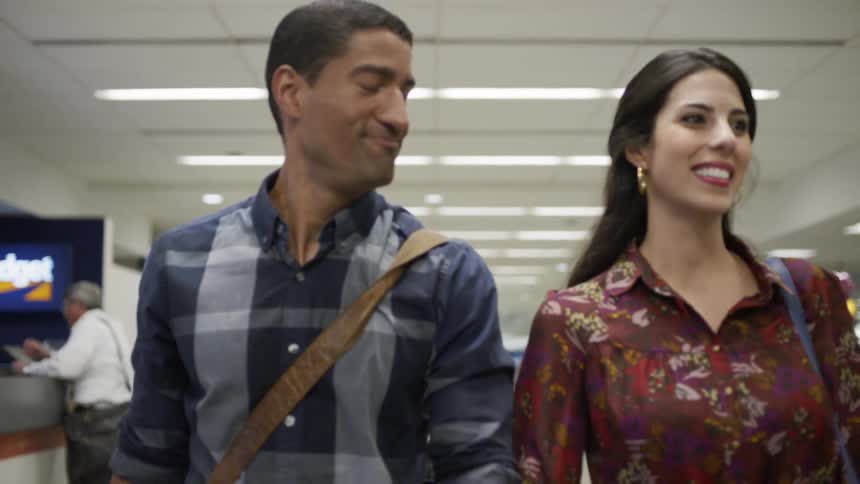 Man and woman walk through an office