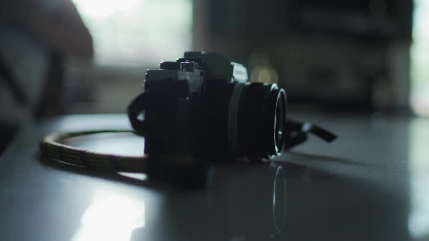 Person lifts camera off of a table