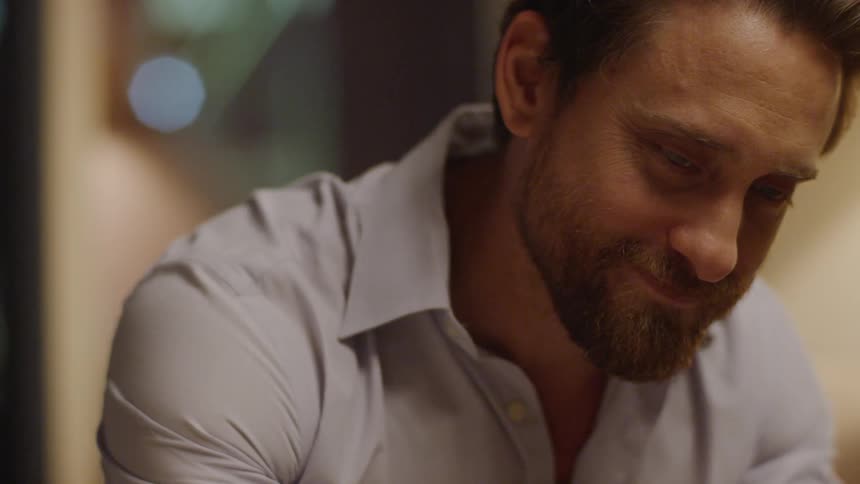 Man sits gazing and smiling