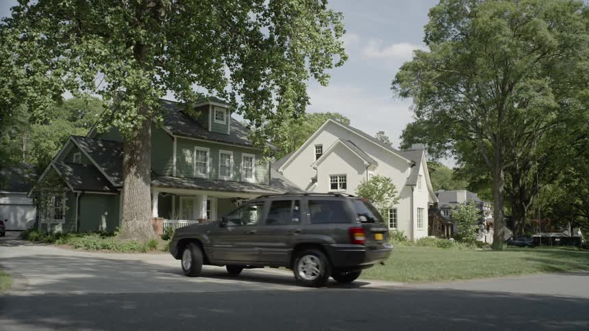 An suv pulls up to a house