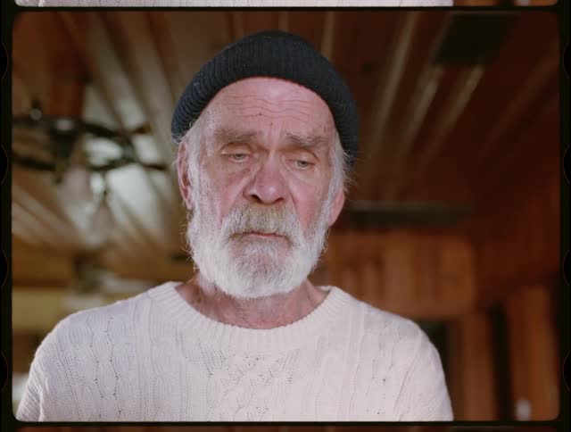 An elderly man looks sad