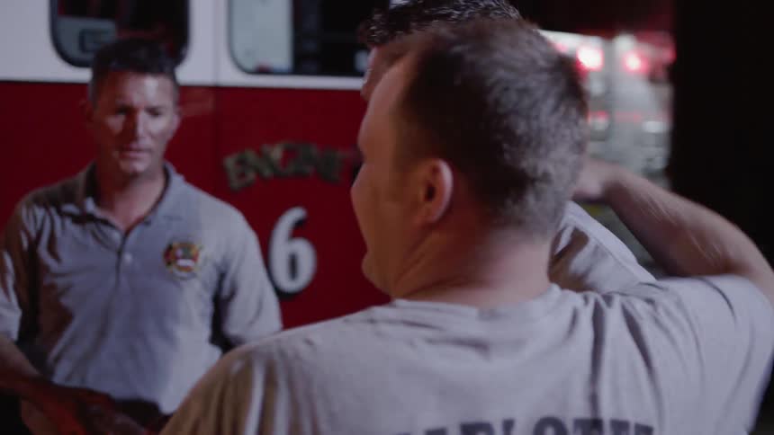 Firefighters greet each other at the fire department