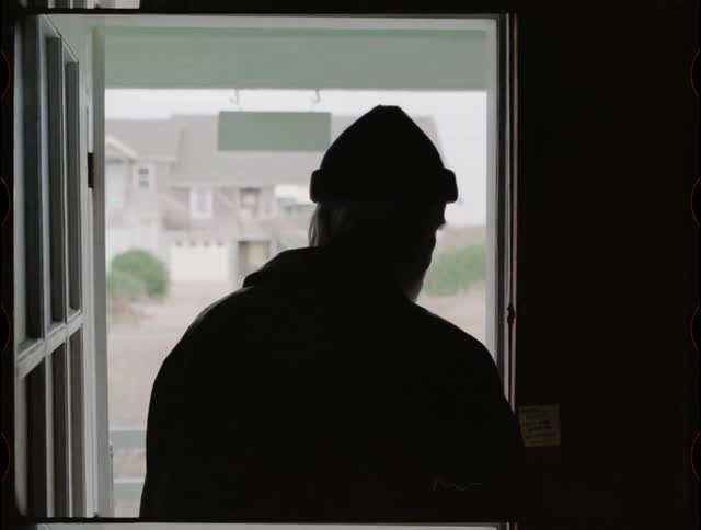 Man walks towards an open front door