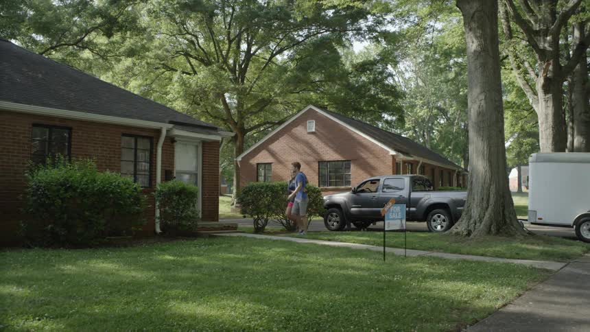 Man and woman walking into new house in the afternoon