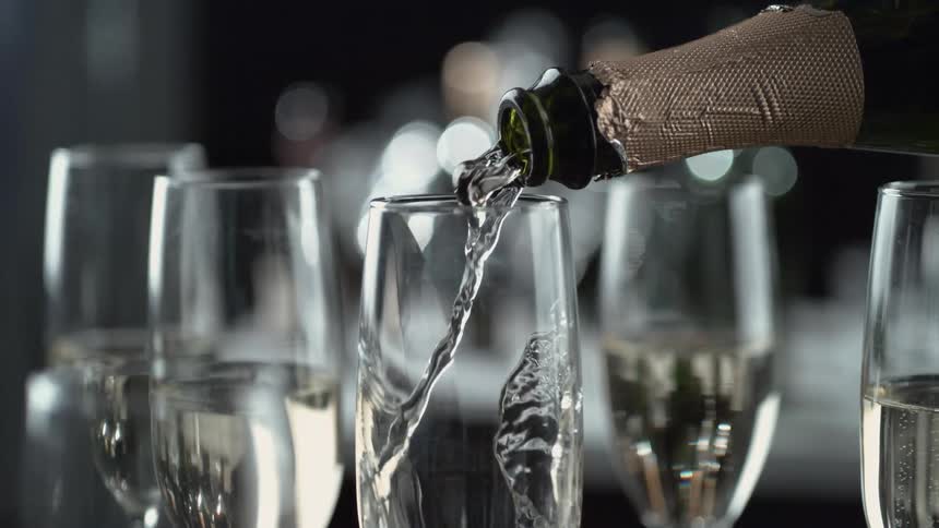 Champagne flows from a bottle into a glass