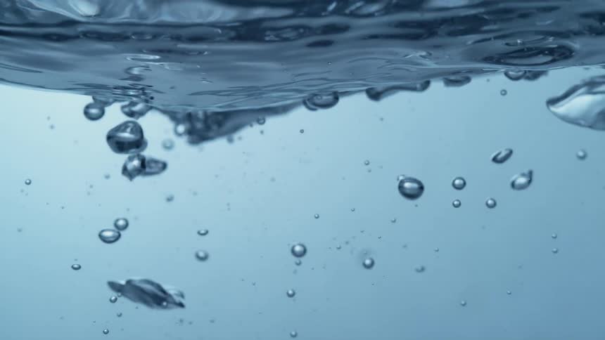 Ice cubes fall into water