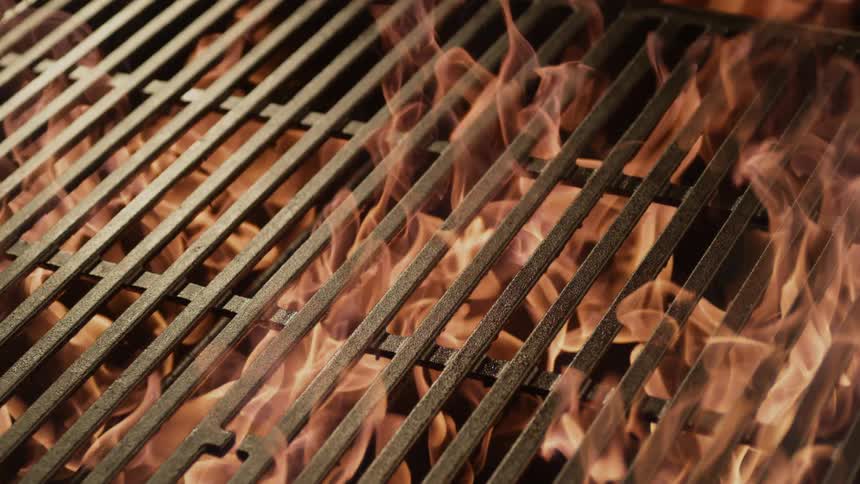 A fire burns in a grill