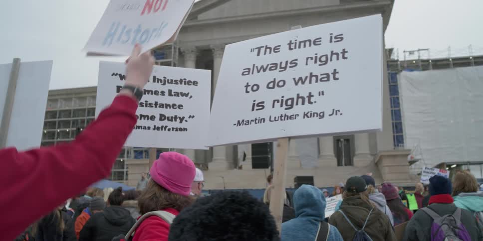 People are protesting on a cloudy day