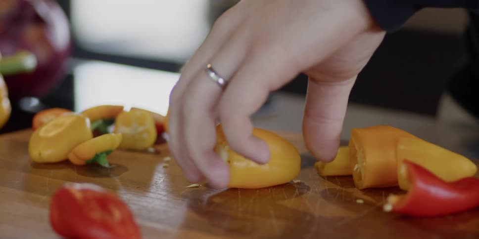 Cutting peppers in kitchen