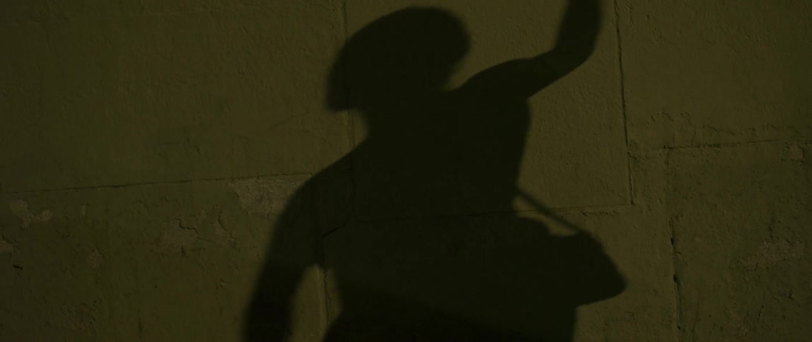 Woman listening to music and dancing in the street at night