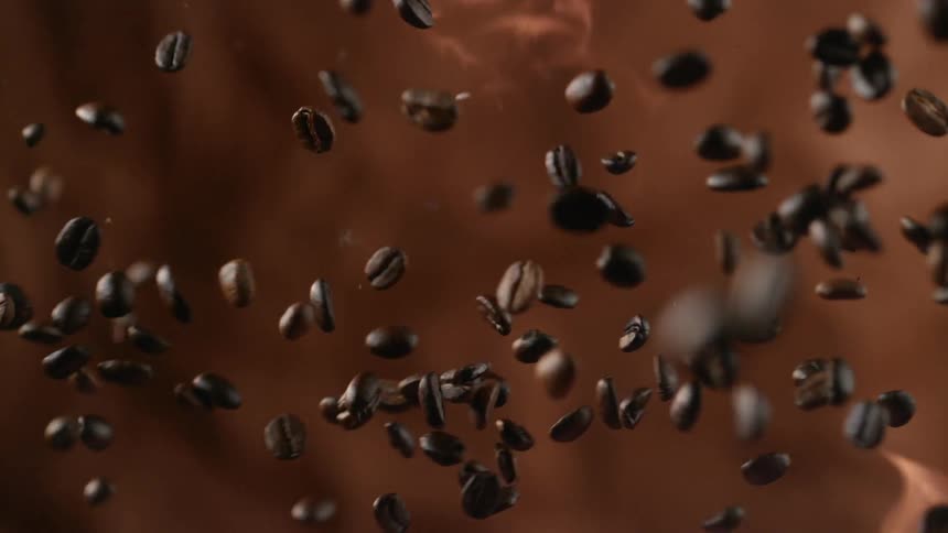 Coffee beans are tossed into the flames