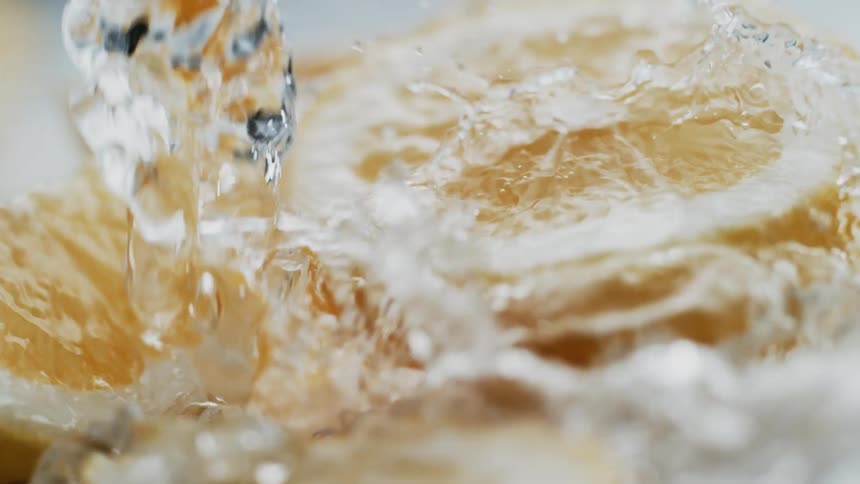 Water is poured onto sliced lemons