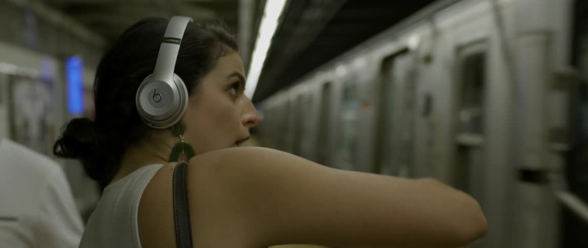 A woman dances as a train passes