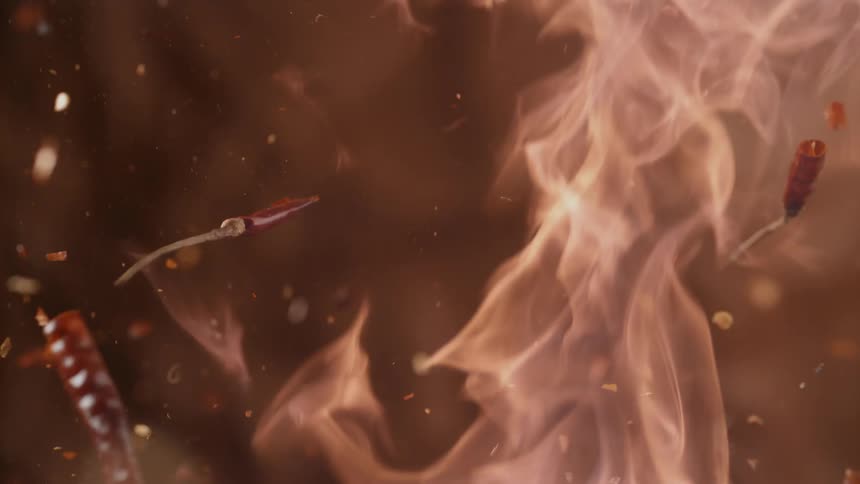 Hot peppers and spices flying through flames