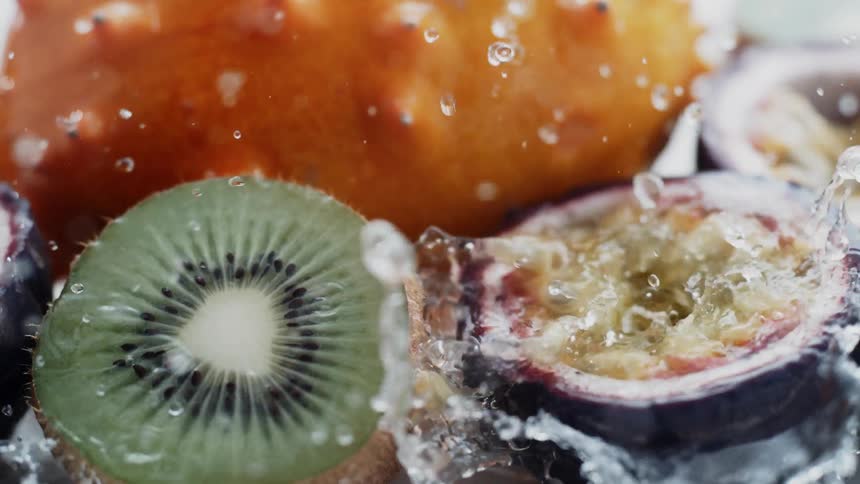 Water is pouring over fresh tropical fruits