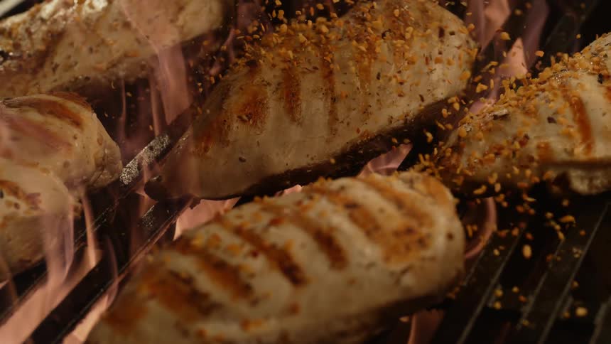 Chicken is cooked on the flaming grill