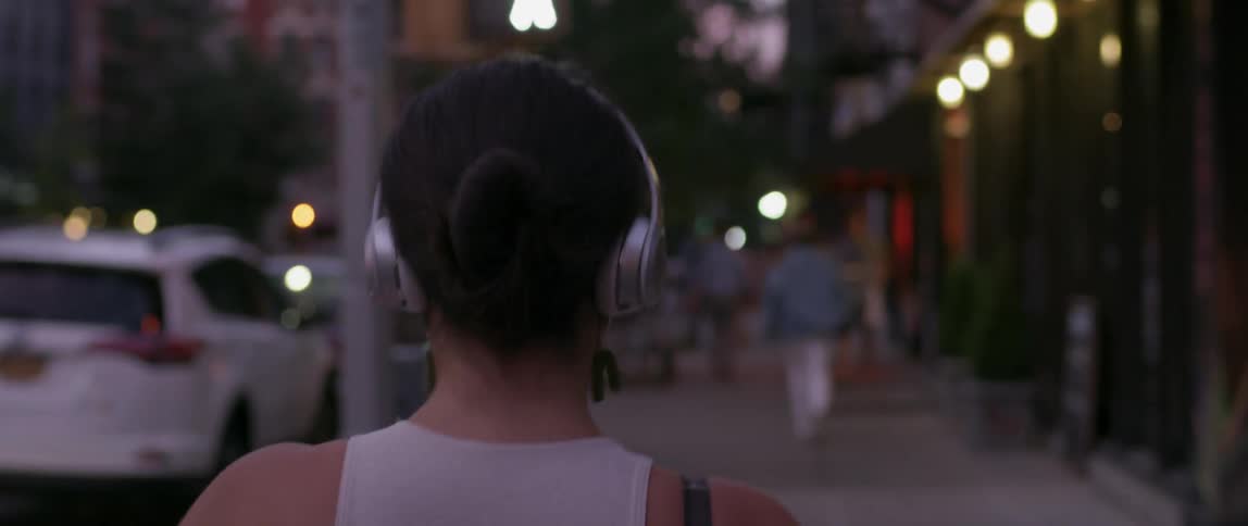 A woman dances on the city sidewalk