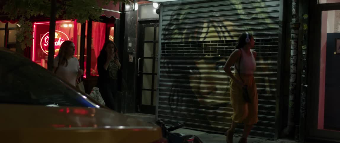 A woman dances playfully at night