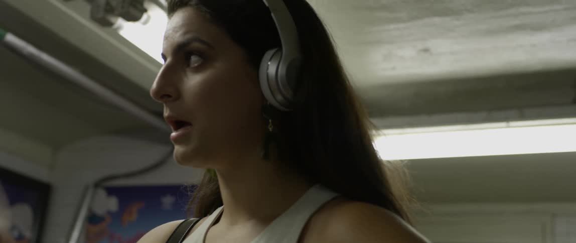 Woman listening to music while fanning herself