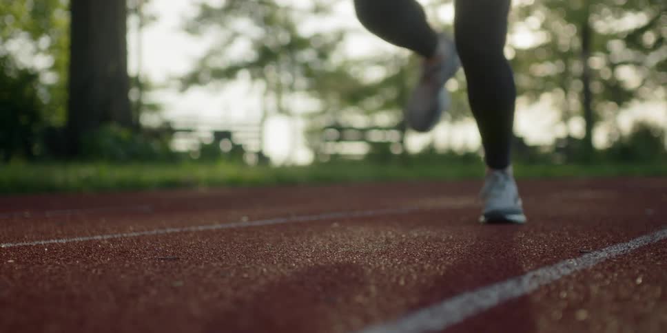 Person is running on a track during the day