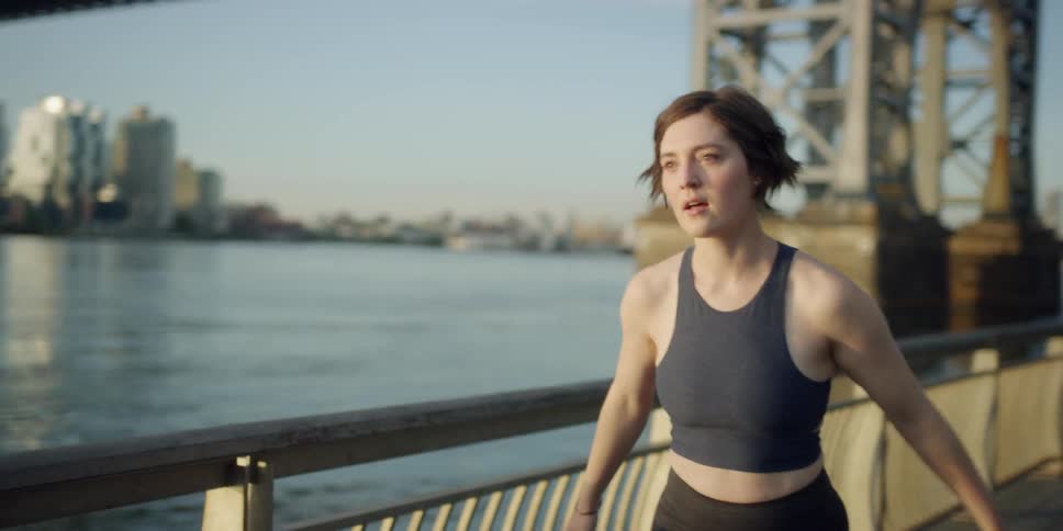 A woman stretches then goes for a run