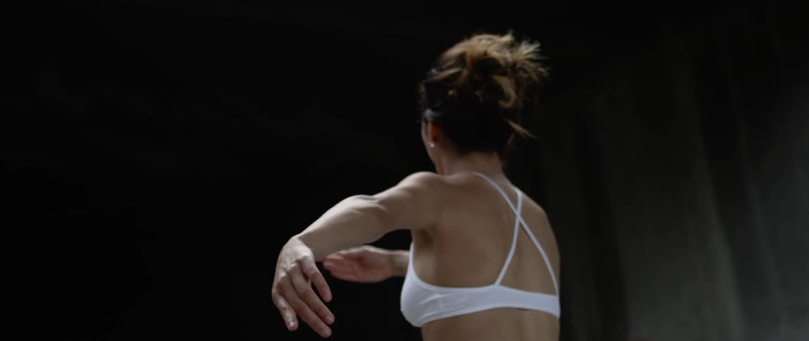 A ballet dancer dances under the bridge