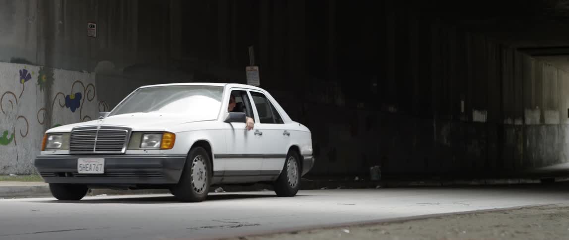 A vehicle is driving in an urban area at night