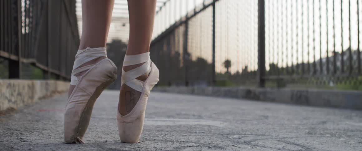 A ballet dancer balances on her toes