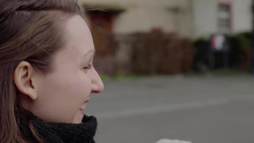 Woman laughs while in the street