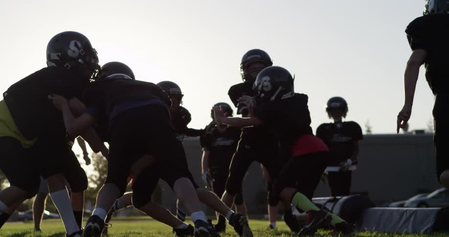 Children at football practice on a sunny day