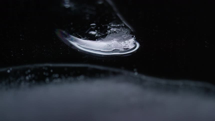 Water shining on black plastic