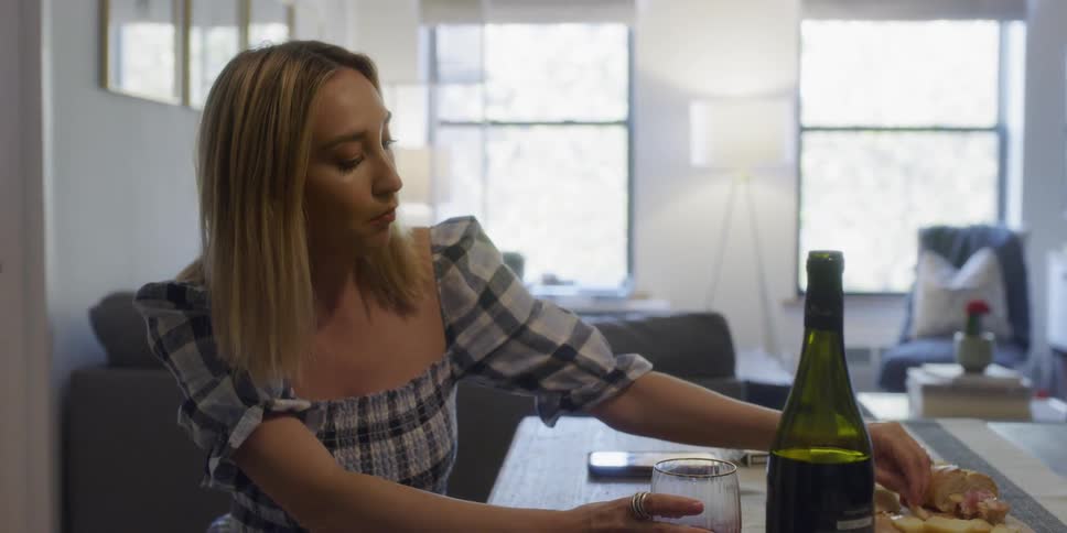 A woman sits at the table eating