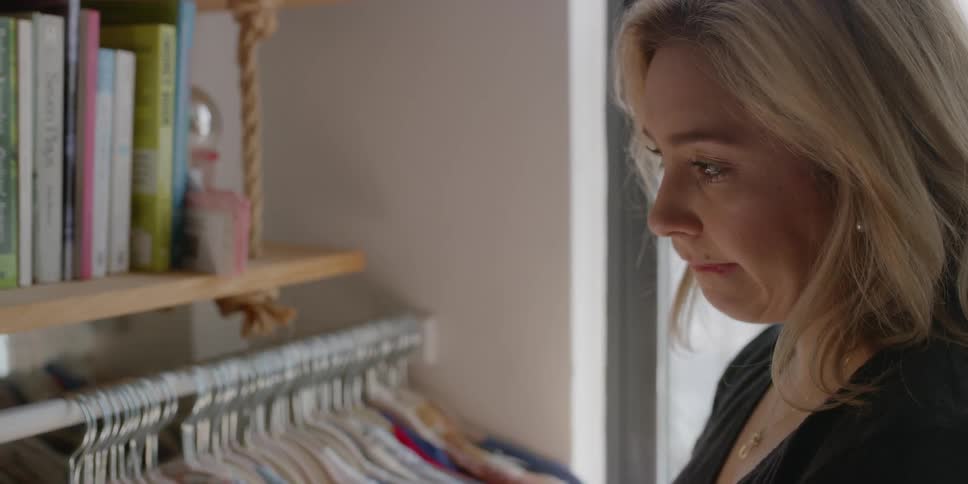 Woman looking through her closet