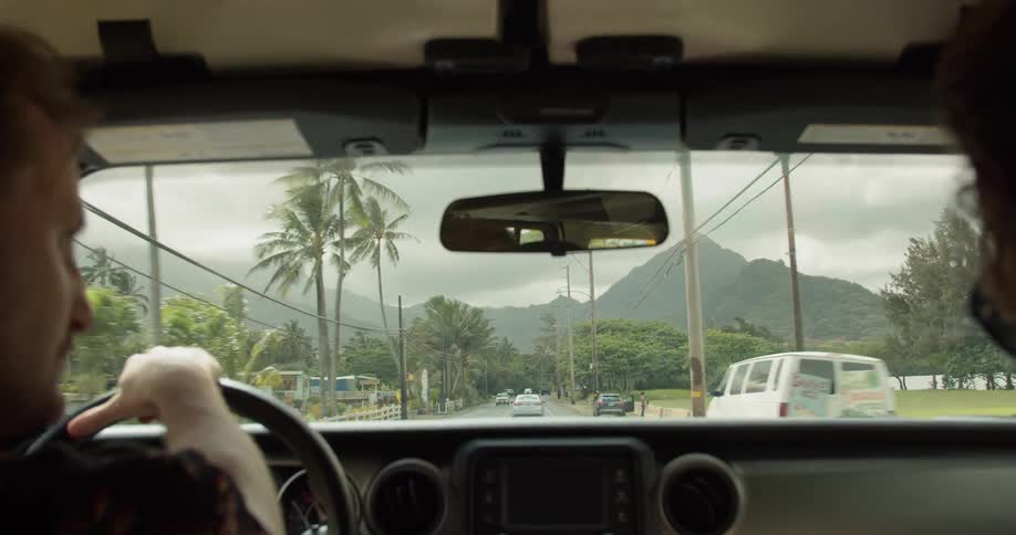 A man drives a car on a cloudy day