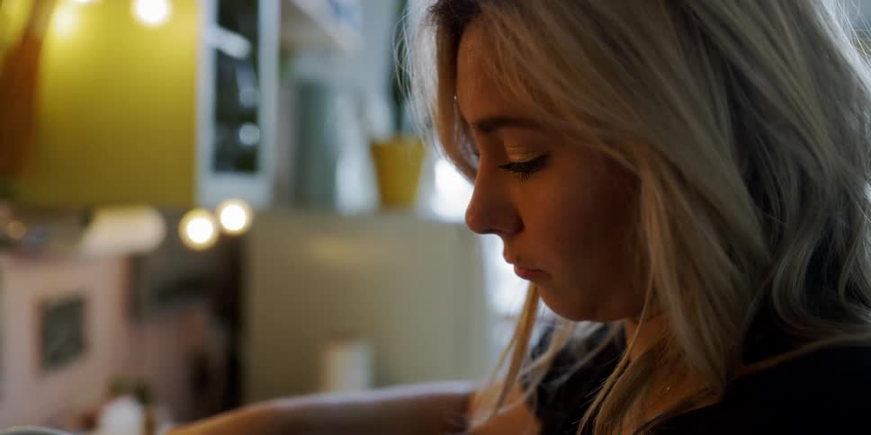A woman pours hot liquid in the kitchen