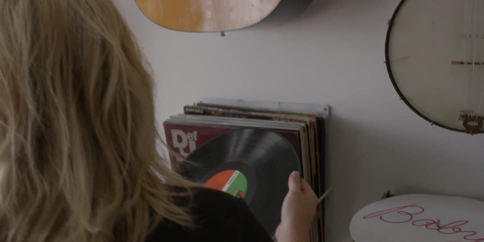 A woman sets a record to play