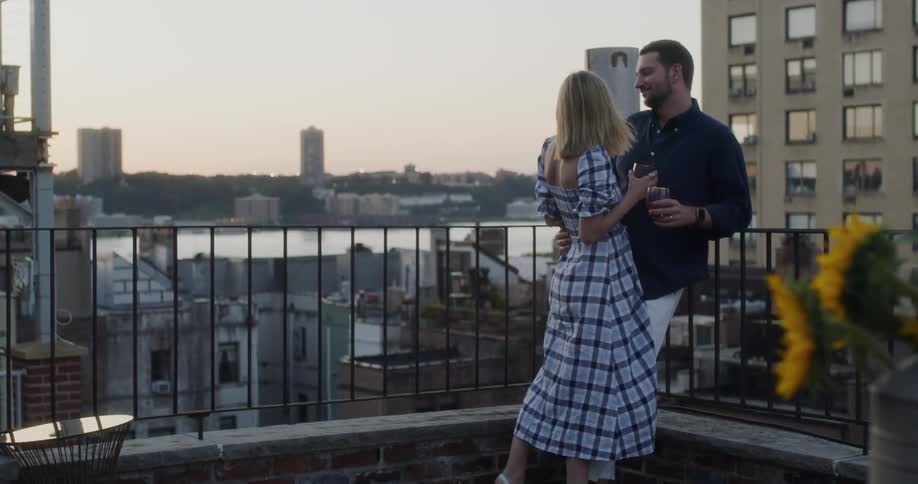 Man and woman on balcony embrace