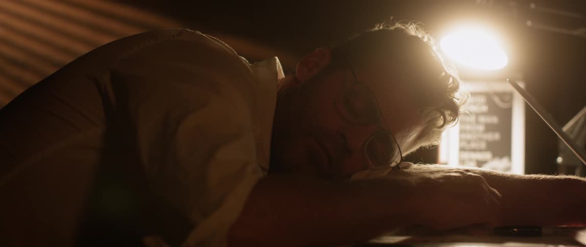 A man resting on the table suddenly gets up