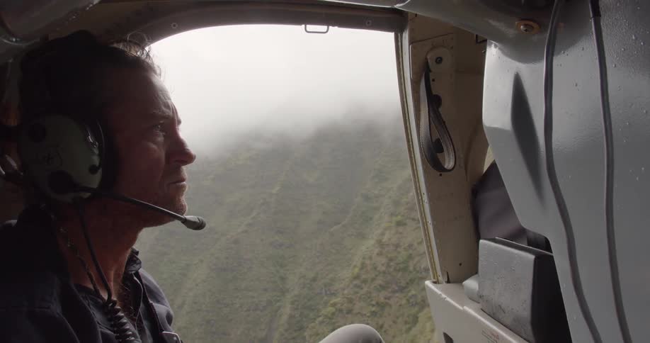 A man is taking a ride in a helicopter