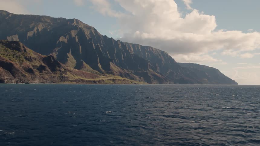 Waves flow by the tall mountain