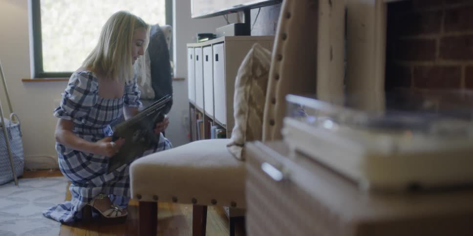 A woman browses a record collection