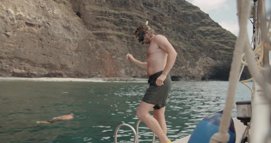 A snorkeler jumps off a boat